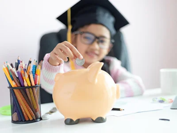 Child saving money in piggy bank